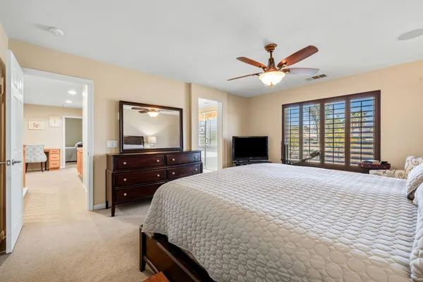 a bedroom with a bed and a large window