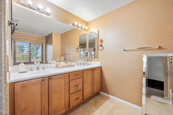 a bathroom with a double vanity sink and a mirror