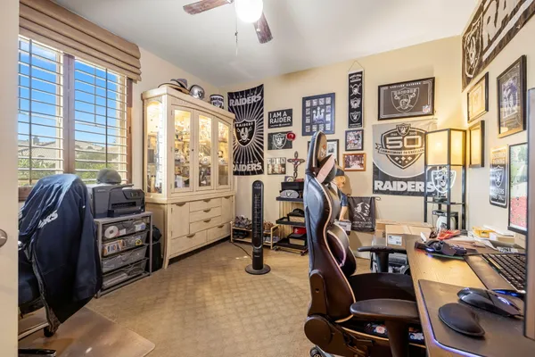 a view of a workspace with furniture and a window