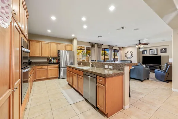 a kitchen with kitchen island granite countertop lots of counter top space and stainless steel appliances