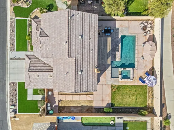 an aerial view of a house with a yard