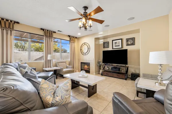 a living room with furniture a large window and a flat screen tv