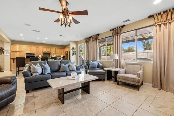 a living room with furniture ceiling fan and a rug