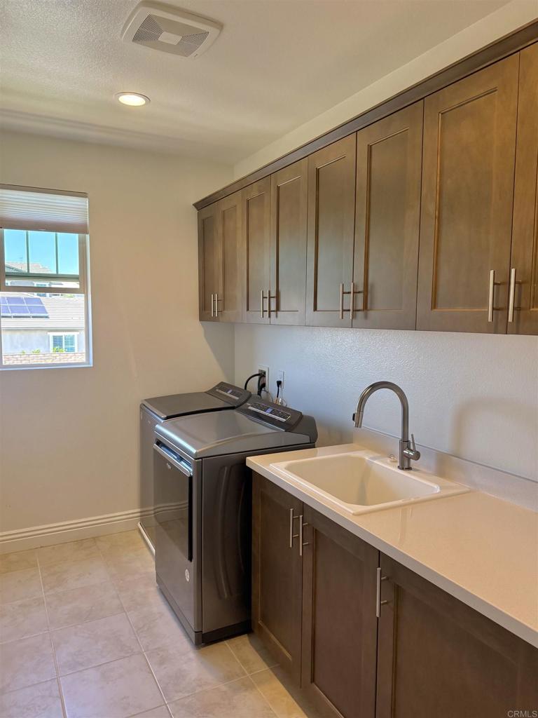 39529 Dayspring Way Temecula, CA 92591 - Photo 36 of 49 a view of a kitchen with a sink a stove and cabinets