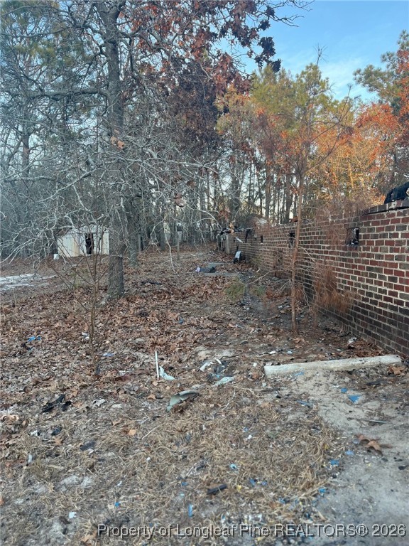 291 Calvin Road Cameron, NC 28326 - Photo 5 of 6 a view of a yard with trees in the background