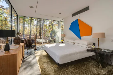 a bed room with a bed and a chair