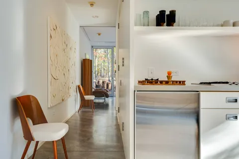 a hallway with dining room and furniture