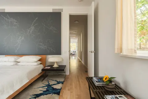 a bedroom with bed and large window