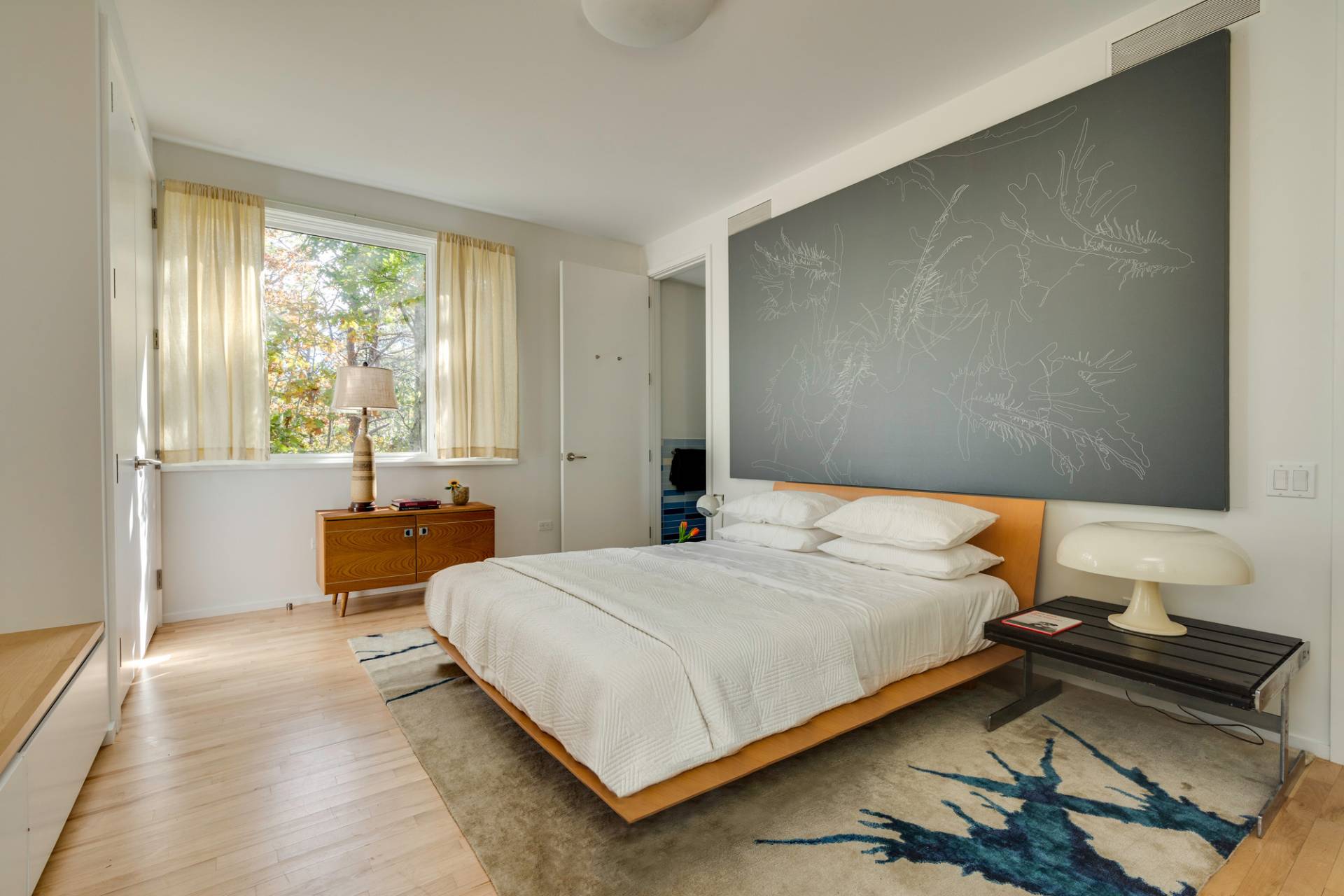 986 & 988 Noyac Path Water Mill, NY 11976 - Photo 27 of 33 a bedroom with a bed and wooden floor