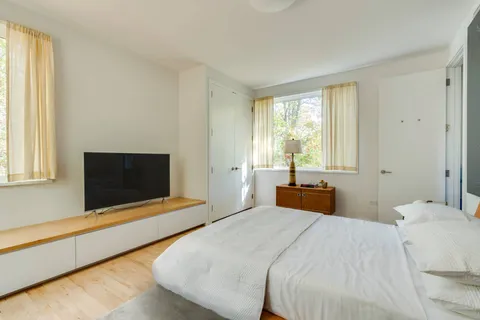 a bedroom with a bed and a table