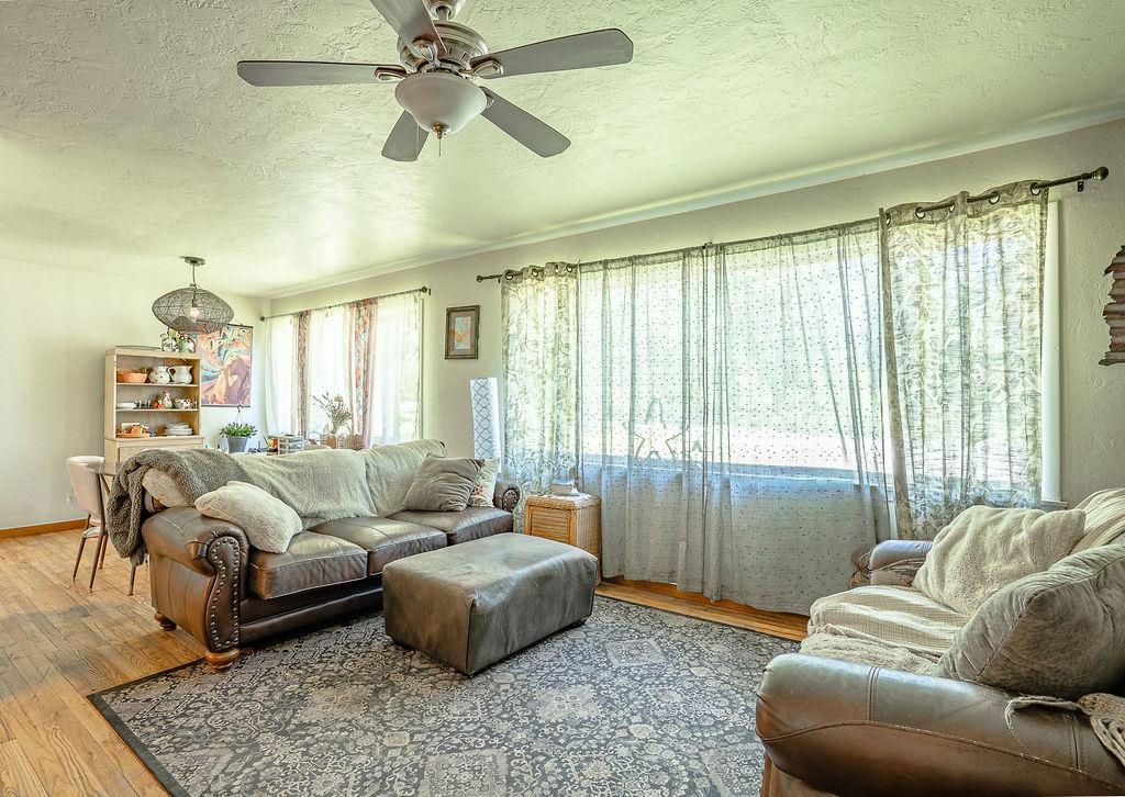 470 Riverside Avenue Chester, CA 96020 - Photo 3 of 25 a living room with furniture and a large window