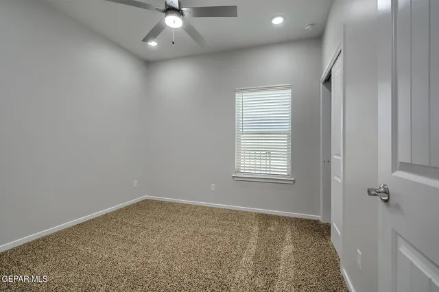 an empty room with windows and closet