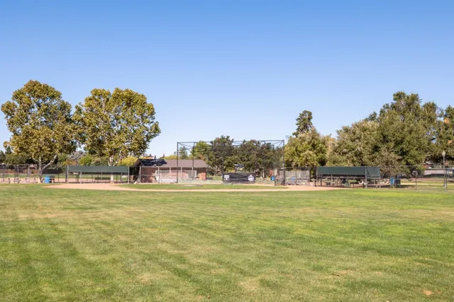 a view of a swimming pool and trees in the background