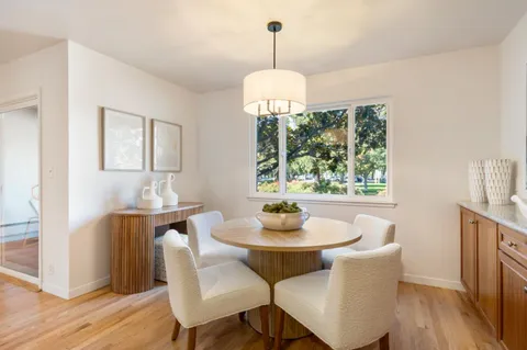 a view of a dining room with furniture window and wooden floor