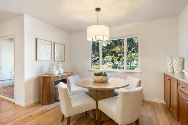 a view of a dining room with furniture window and wooden floor