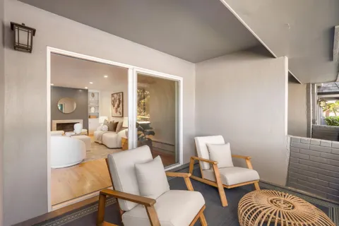 a living room with furniture and a mirror