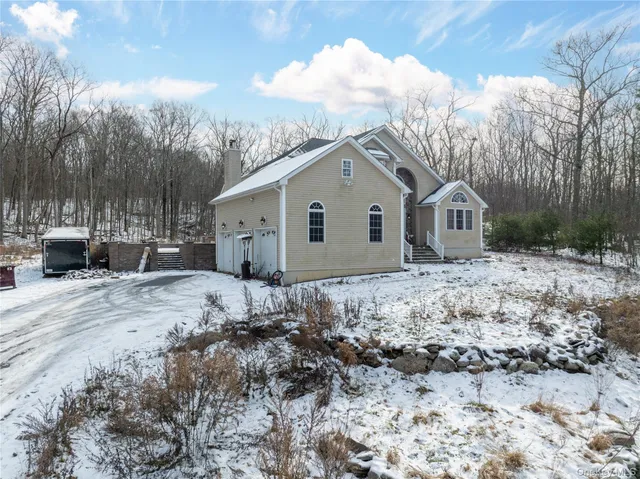 a view of a house with a yard covered in snow