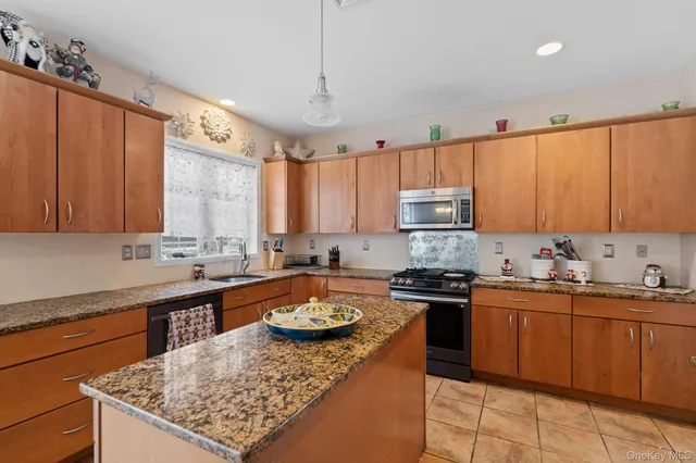 a kitchen with a stove a sink a refrigerator and cabinets