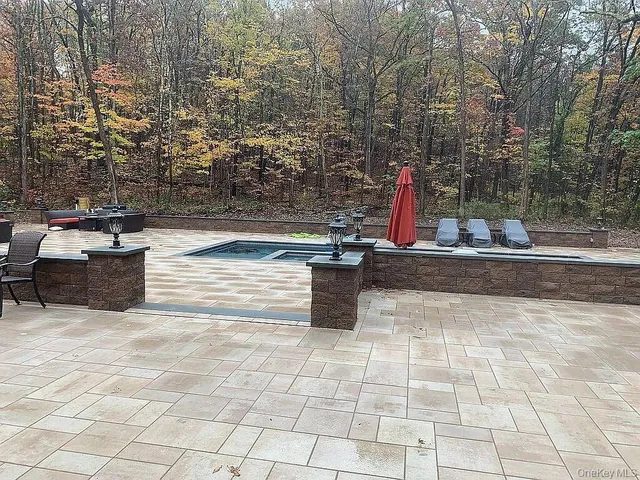 a swimming pool with barbeque in outdoor space
