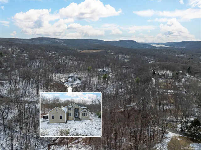 a aerial view of a house with a yard