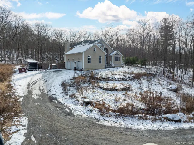 a view of a house with a yard covered in snow