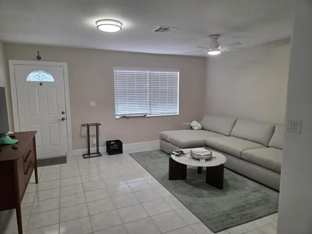 a living room with furniture and a potted plant