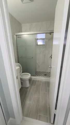 a large bed sitting in a bedroom next to a window