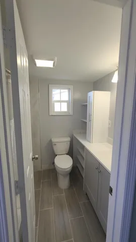 a white toilet sitting next to a bathroom sink