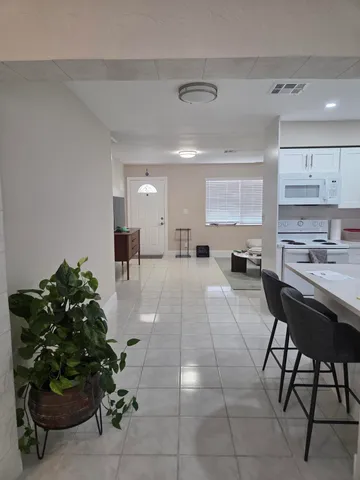 a kitchen with kitchen island a sink cabinets and stainless steel appliances