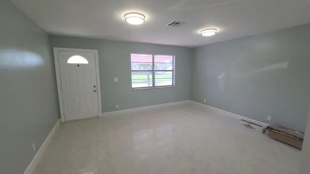 an empty room with windows and closet