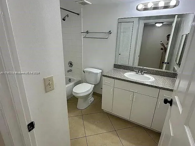 a front view of a house with a garden and a yard