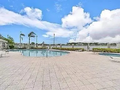 an empty room with chandelier fan