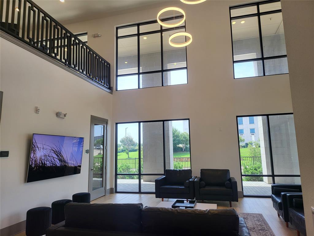 2700 Old Denton Road, Unit 2233 Carrollton, TX 75007 - Photo 13 of 13 a living room with couches a flat tv screen and a dining table with garden view