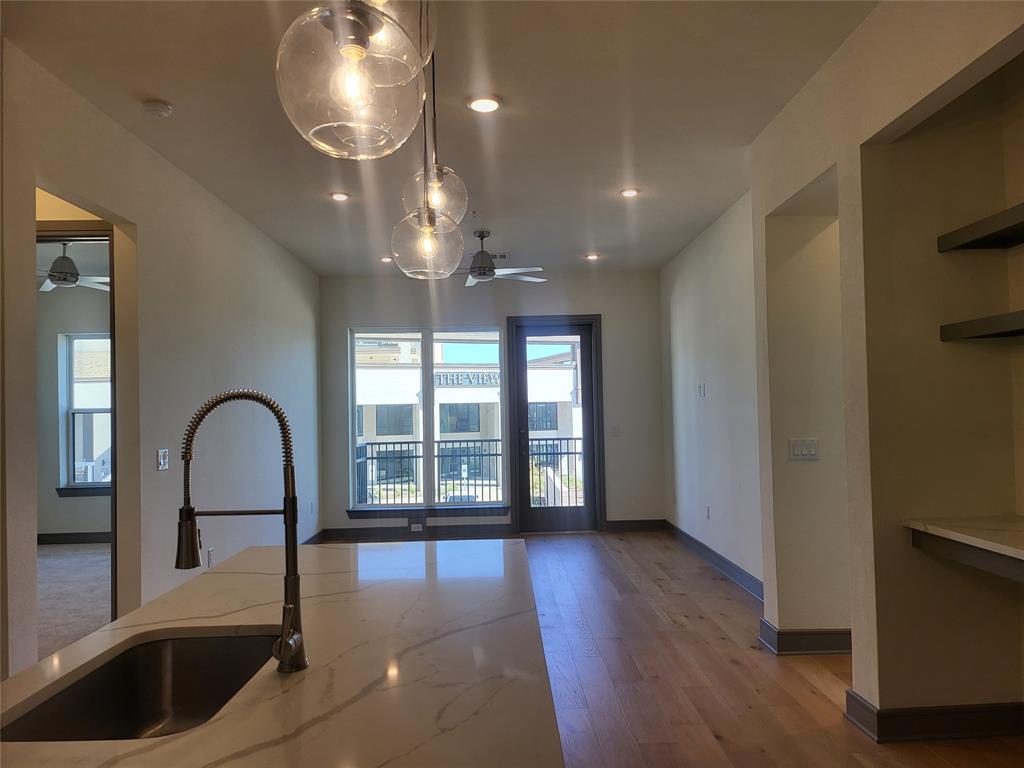 2700 Old Denton Road, Unit 2233 Carrollton, TX 75007 - Photo 3 of 13 a view of a big room with wooden floor and windows