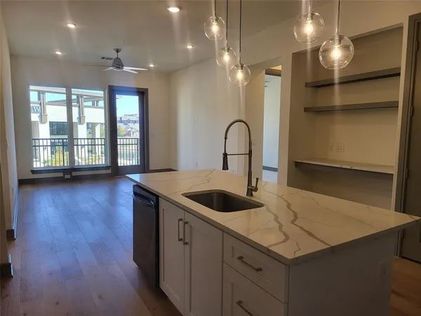 a kitchen with a sink a counter space and a dining table