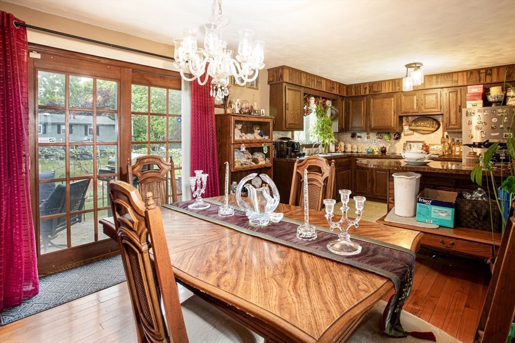 166 Stonehaven Road Fall River, MA 02723 - Photo 6 of 33 a view of a dining room with furniture a chandelier and wooden floor