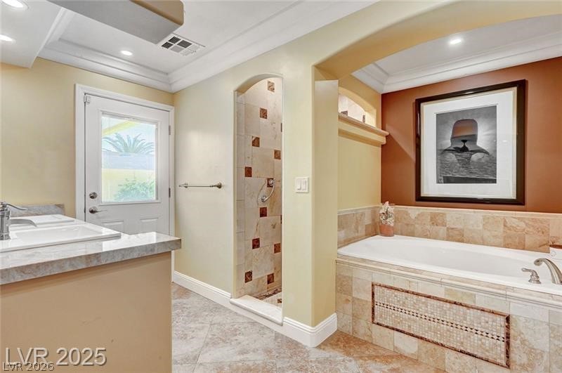 2410 Doherty Way Henderson, NV 89014 - Photo 44 of 63 Bathroom with a shower stall, a garden tub, ornamental molding, recessed lighting, and tile patterned floors
