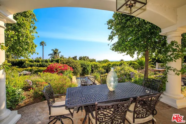 a view of a chairs and table in a backyard
