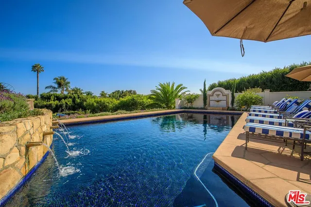 a bedroom with bed and a large window