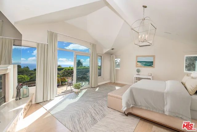 a view of a lake with a bench under an umbrella