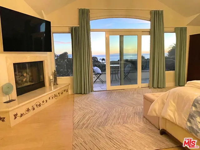 an aerial view of a houses with a yard