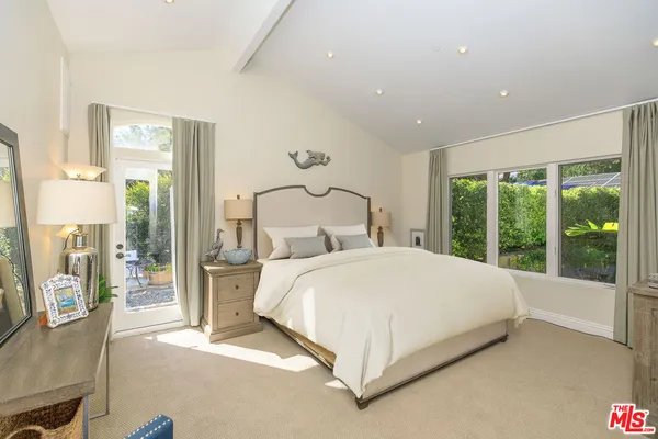a room with pool table and windows
