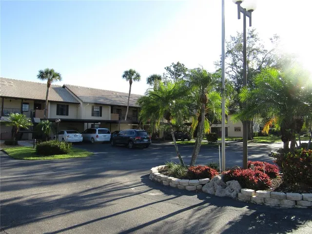a front view of a house with garden and seating area