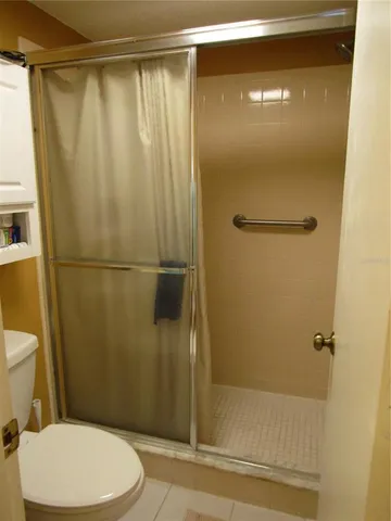 a bathroom with a shower a toilet and a sink