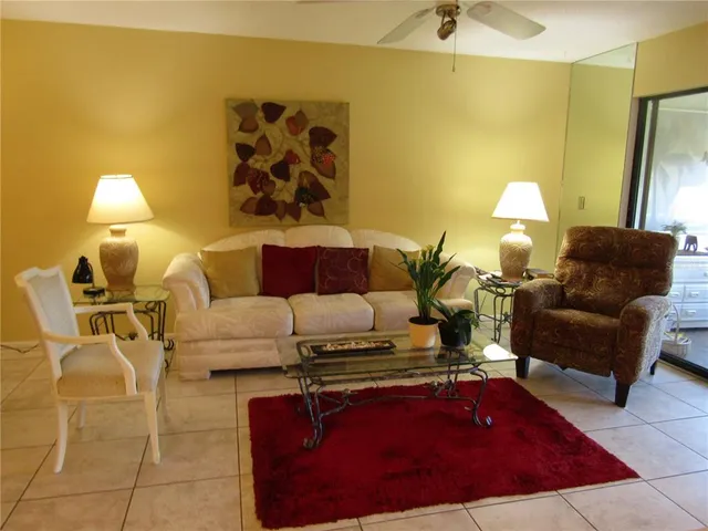 a living room with furniture and a lamp