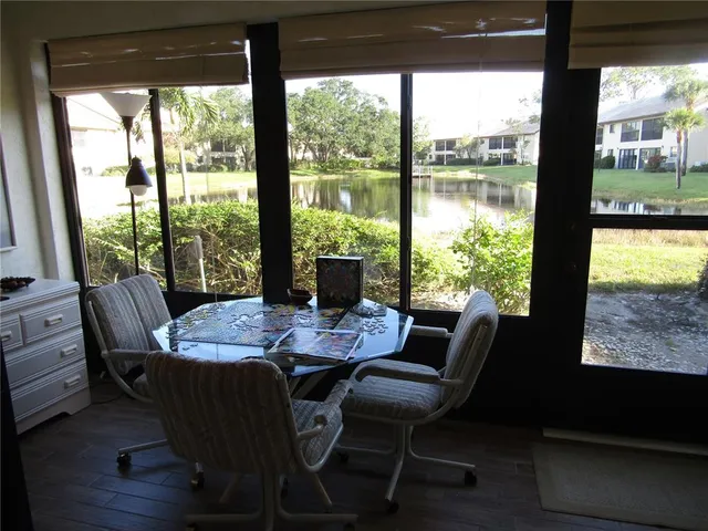 a view of a dining room with furniture large windows and wooden floor