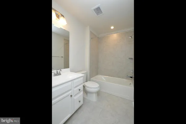 a bathroom with a toilet a sink and bathtub