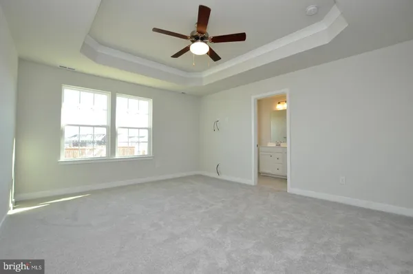 a view of room with ceiling fan and window