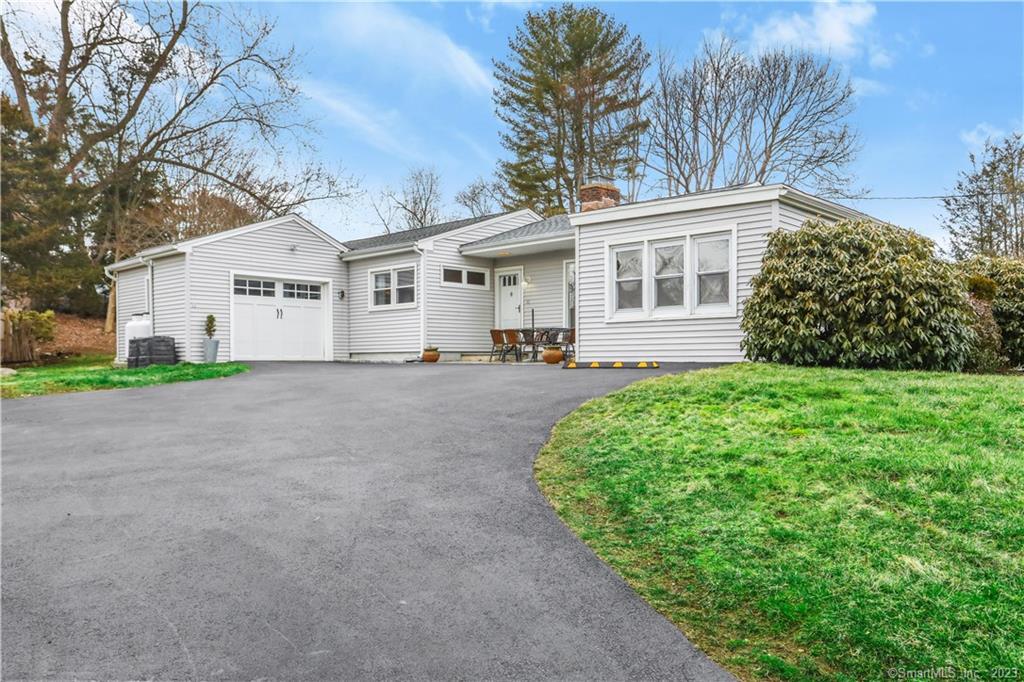 a front view of house with yard and green space