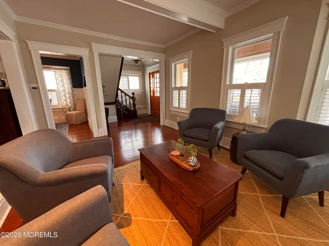 a living room with furniture and wooden floor